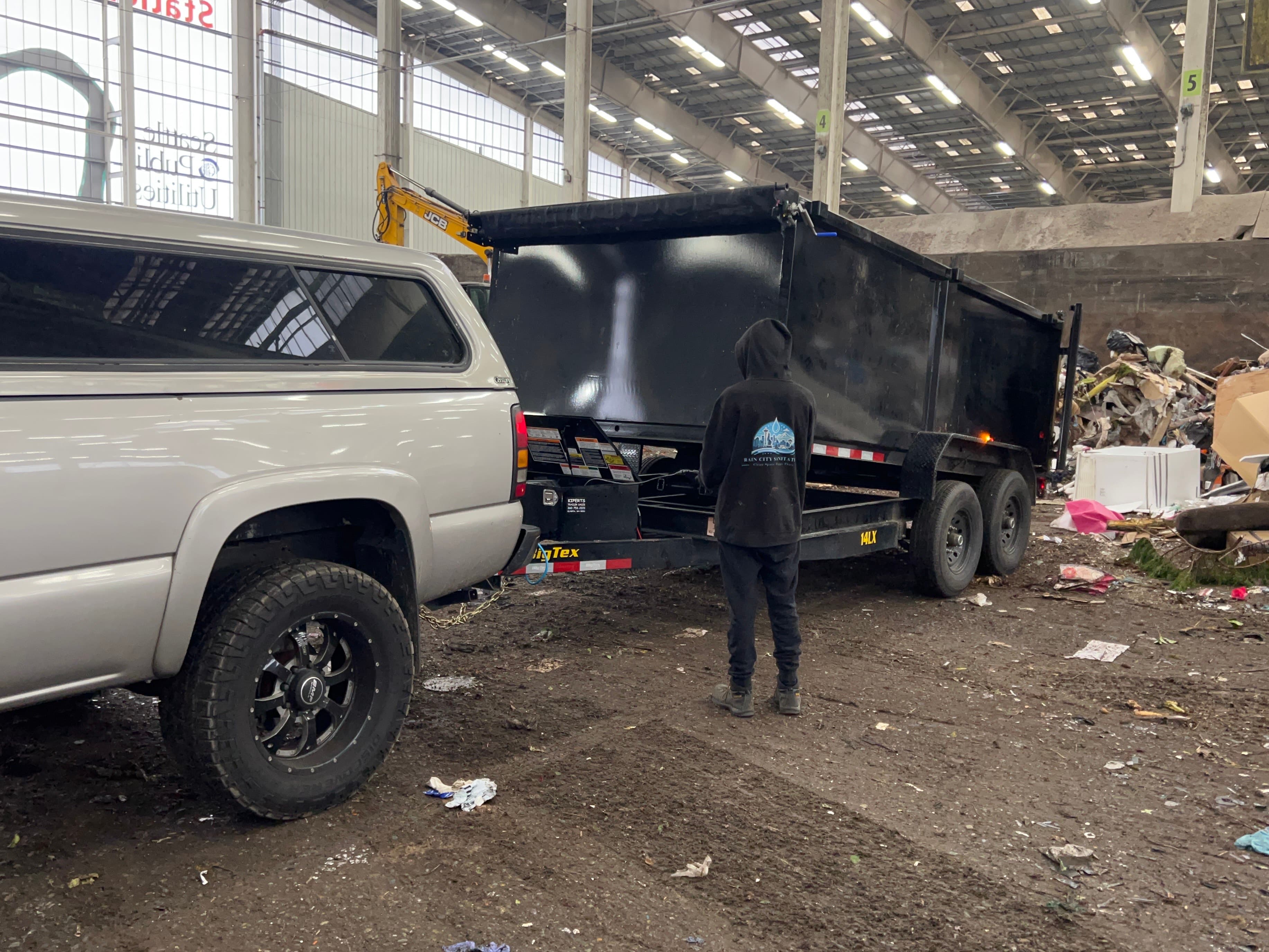Rain City Sanitation truck and crew at a disposal facility